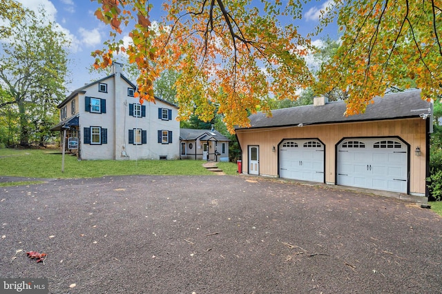 view of front of home with a garage and a front lawn