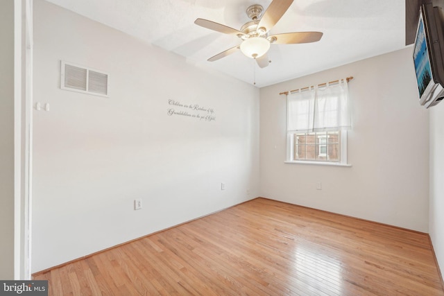 unfurnished room with ceiling fan and light wood-type flooring