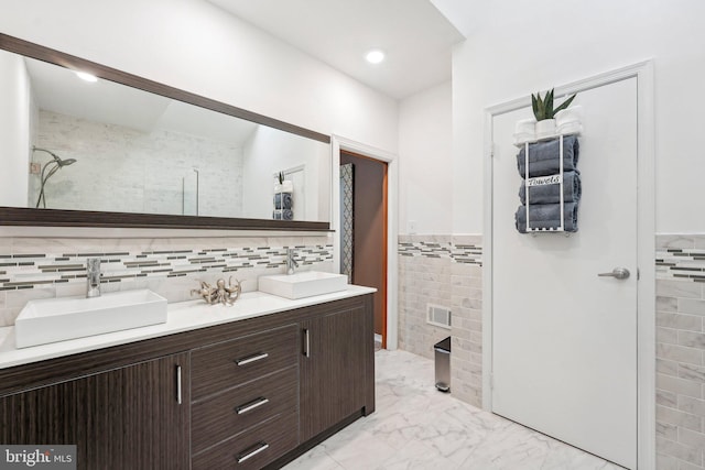 bathroom with vanity and tile walls