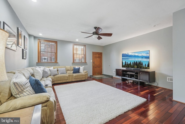 living room with ceiling fan and dark hardwood / wood-style flooring