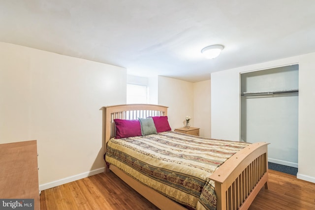 bedroom with hardwood / wood-style flooring and a closet