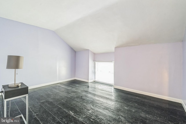 interior space with lofted ceiling and dark wood-type flooring