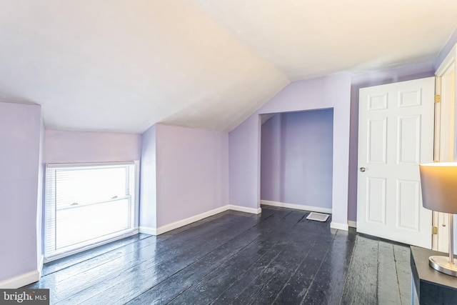 bonus room with vaulted ceiling and dark hardwood / wood-style floors