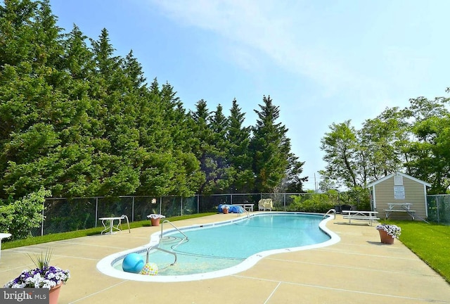 view of swimming pool featuring a yard and a patio area