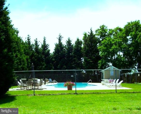 view of pool with a lawn and a patio area