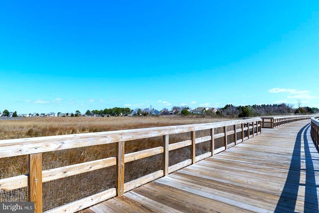 view of dock with a rural view