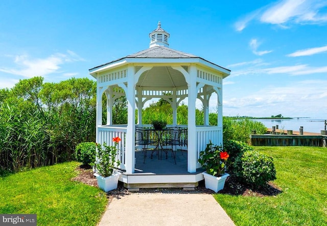 exterior space with a water view, a lawn, and a gazebo