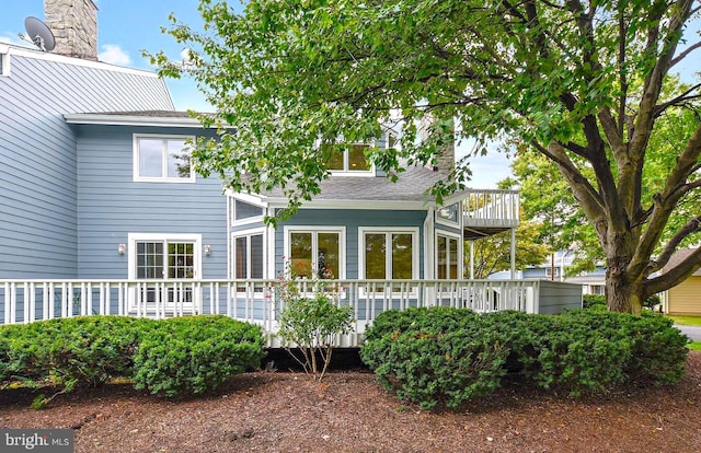 back of house featuring a wooden deck