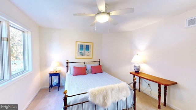 bedroom with ceiling fan and light carpet