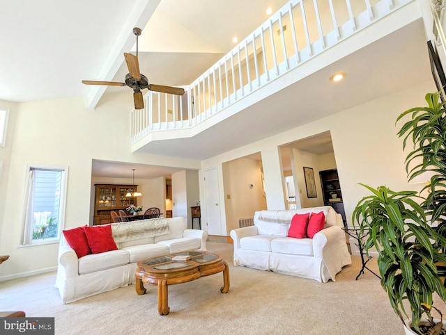 living room featuring beamed ceiling, ceiling fan, light carpet, and high vaulted ceiling