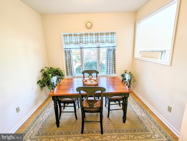 dining space with hardwood / wood-style floors