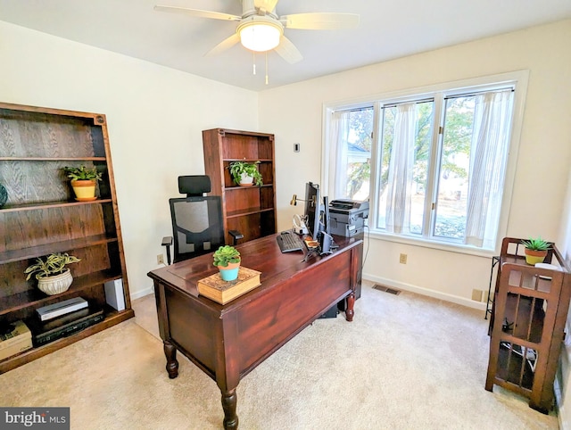 carpeted home office with ceiling fan