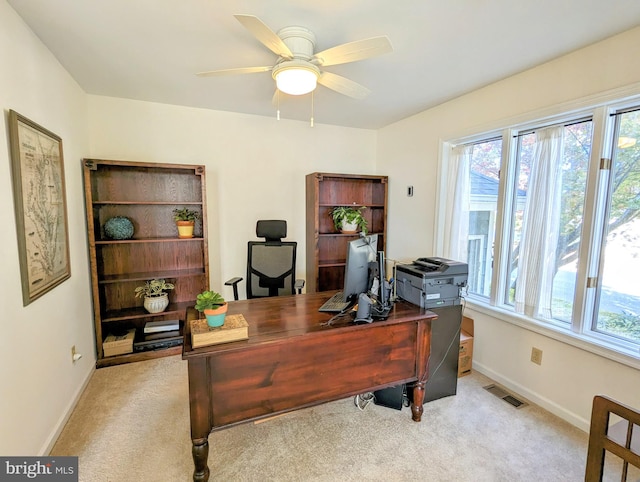 home office with light carpet and ceiling fan