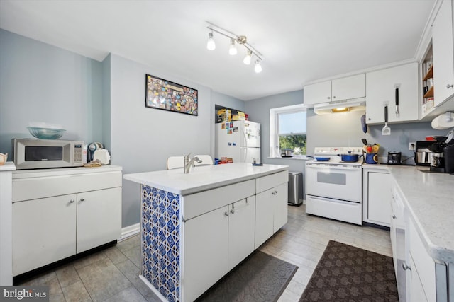 kitchen featuring white cabinets, sink, light hardwood / wood-style floors, a center island, and white appliances