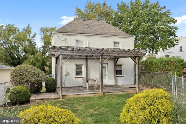 rear view of property with a yard, a deck, and a pergola