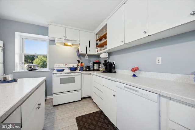 kitchen featuring white cabinets and white appliances