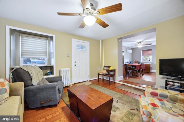 living room featuring ceiling fan, radiator heating unit, and hardwood / wood-style floors