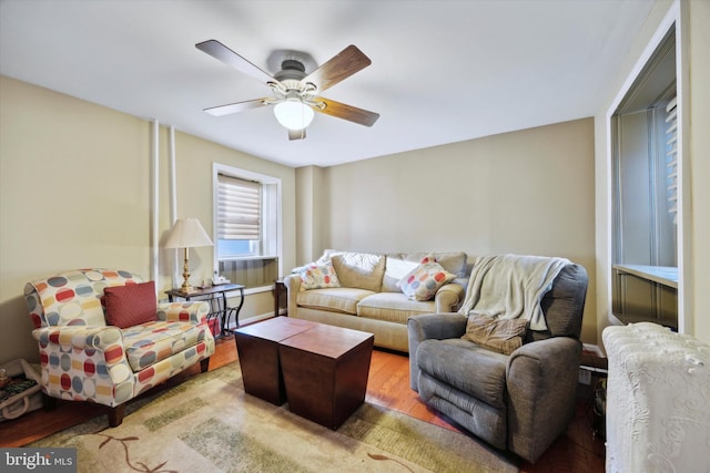 living room featuring light hardwood / wood-style floors and ceiling fan