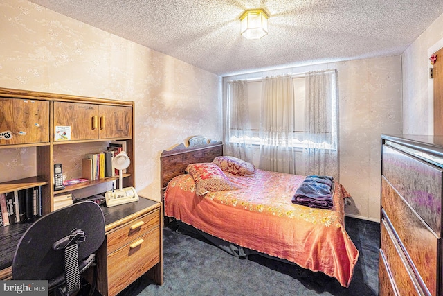 carpeted bedroom featuring a textured ceiling