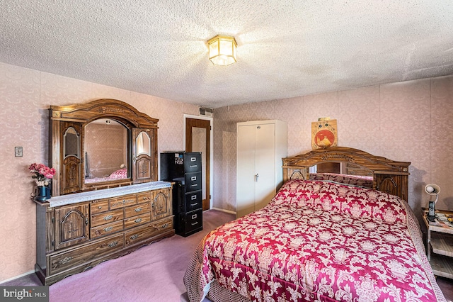 carpeted bedroom featuring a textured ceiling