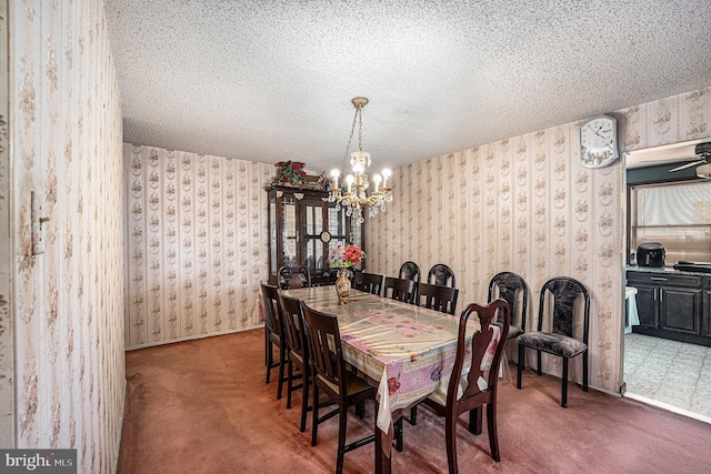 carpeted dining room with a textured ceiling and a notable chandelier