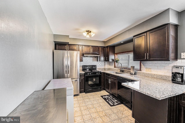 kitchen featuring light stone countertops, tasteful backsplash, dark brown cabinetry, sink, and black appliances