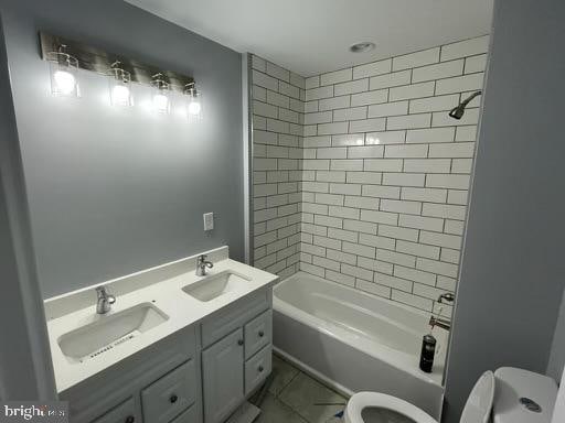 full bathroom with vanity, toilet, and tiled shower / bath combo