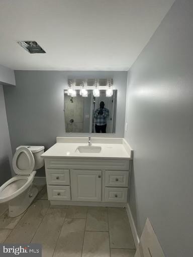 bathroom featuring vanity and toilet