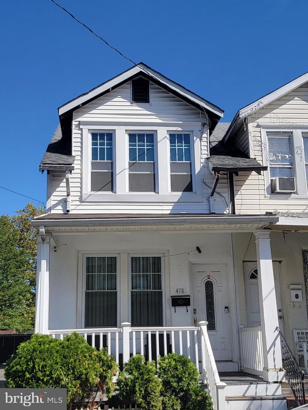 view of front of house with cooling unit and covered porch