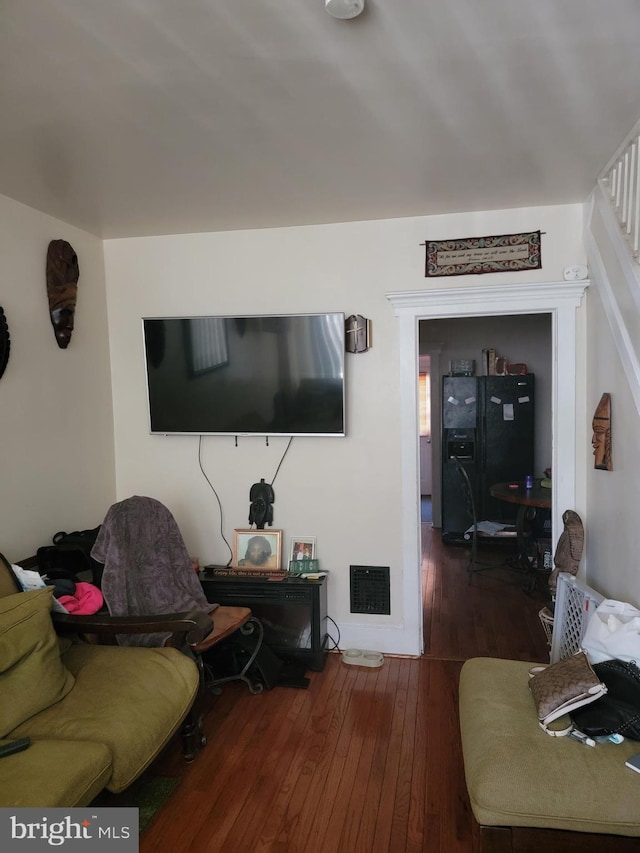 living room with dark hardwood / wood-style flooring