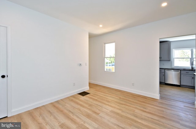 empty room with sink and light wood-type flooring