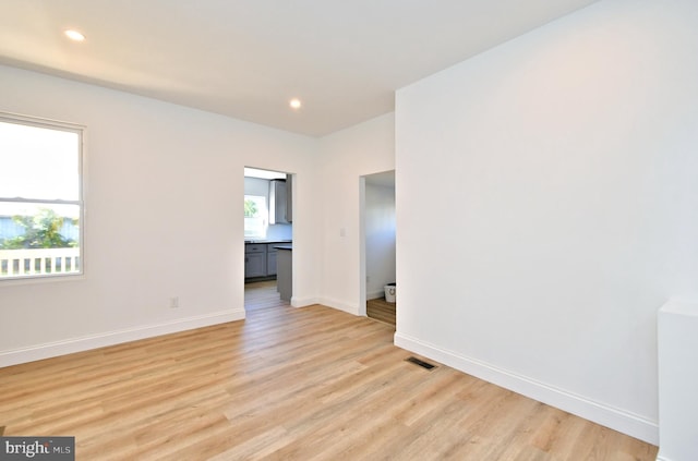 empty room featuring light hardwood / wood-style floors and a healthy amount of sunlight