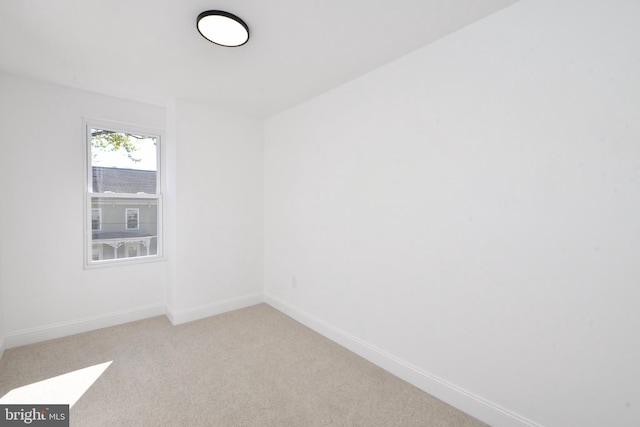 spare room with light colored carpet