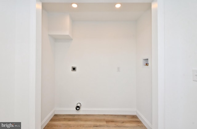 washroom with electric dryer hookup, washer hookup, and light hardwood / wood-style flooring