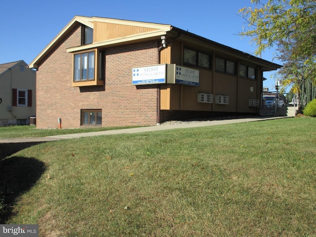 view of side of home featuring a lawn