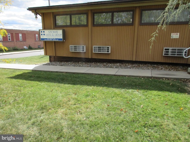 view of side of home featuring a yard