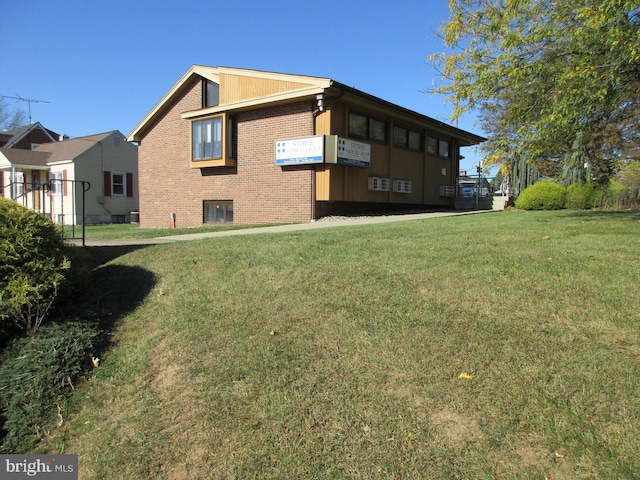 view of side of property with a yard