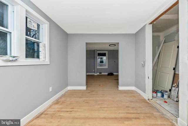 hallway with light hardwood / wood-style floors