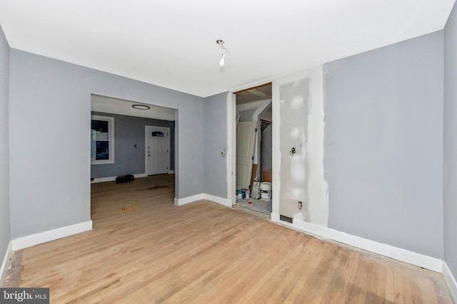 unfurnished room with light hardwood / wood-style floors