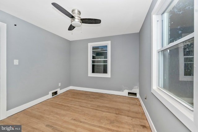 empty room with ceiling fan and wood-type flooring