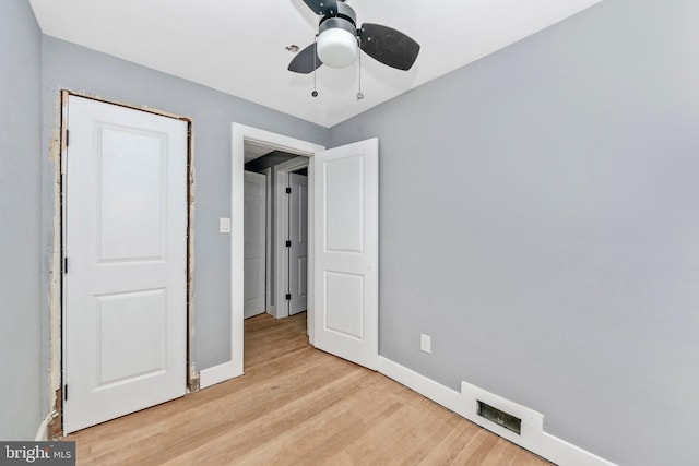 unfurnished bedroom with ceiling fan and light hardwood / wood-style flooring