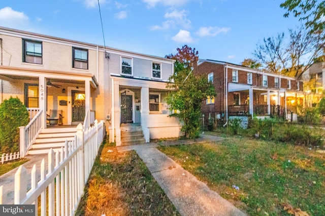 townhome / multi-family property featuring covered porch