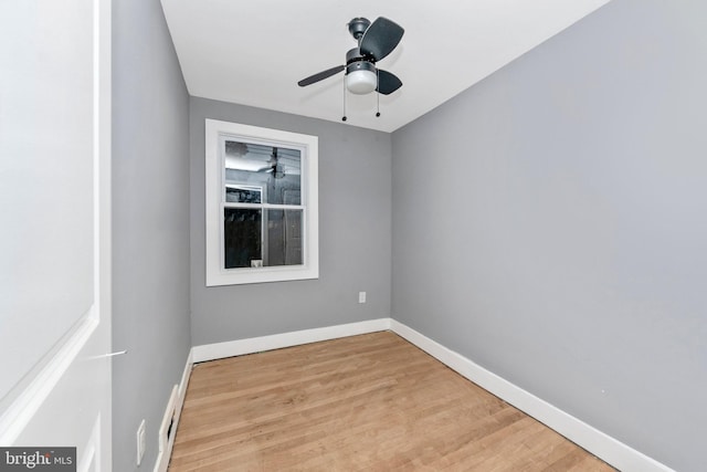 empty room with ceiling fan and light hardwood / wood-style flooring