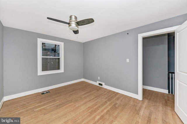 empty room featuring light wood-type flooring and ceiling fan