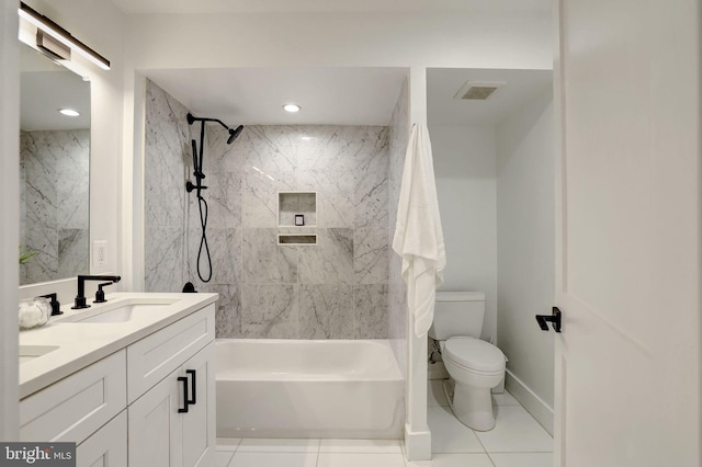 full bathroom with vanity, tile patterned flooring, toilet, and tiled shower / bath combo