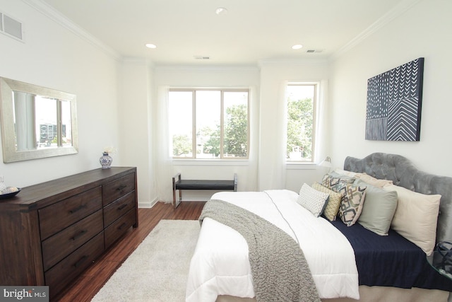 bedroom featuring crown molding and dark hardwood / wood-style flooring