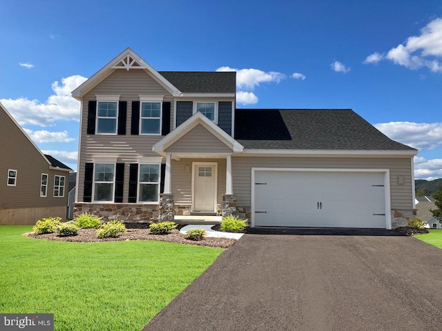 view of front of home with a garage and a front lawn