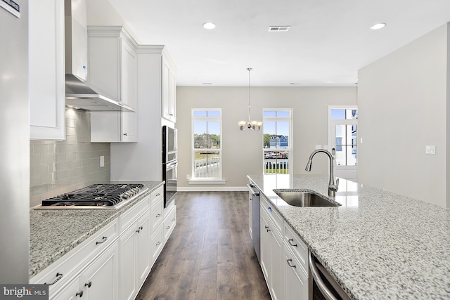 kitchen with stainless steel appliances, white cabinetry, sink, and dark hardwood / wood-style floors