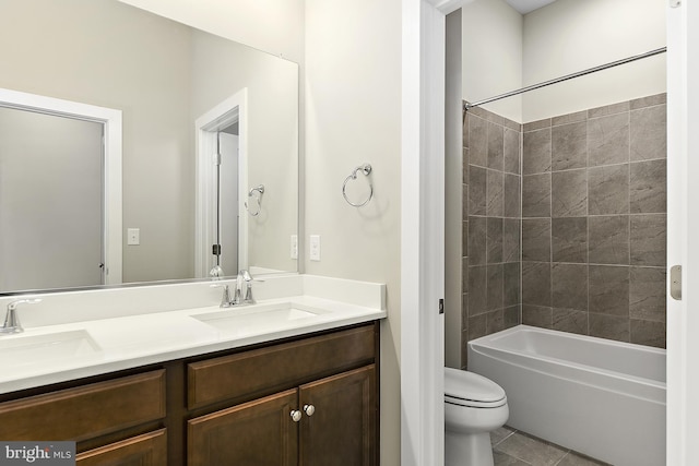 full bathroom with tile patterned floors, vanity, toilet, and tiled shower / bath combo