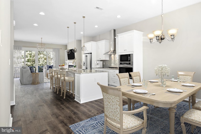 dining room with a chandelier and dark hardwood / wood-style flooring